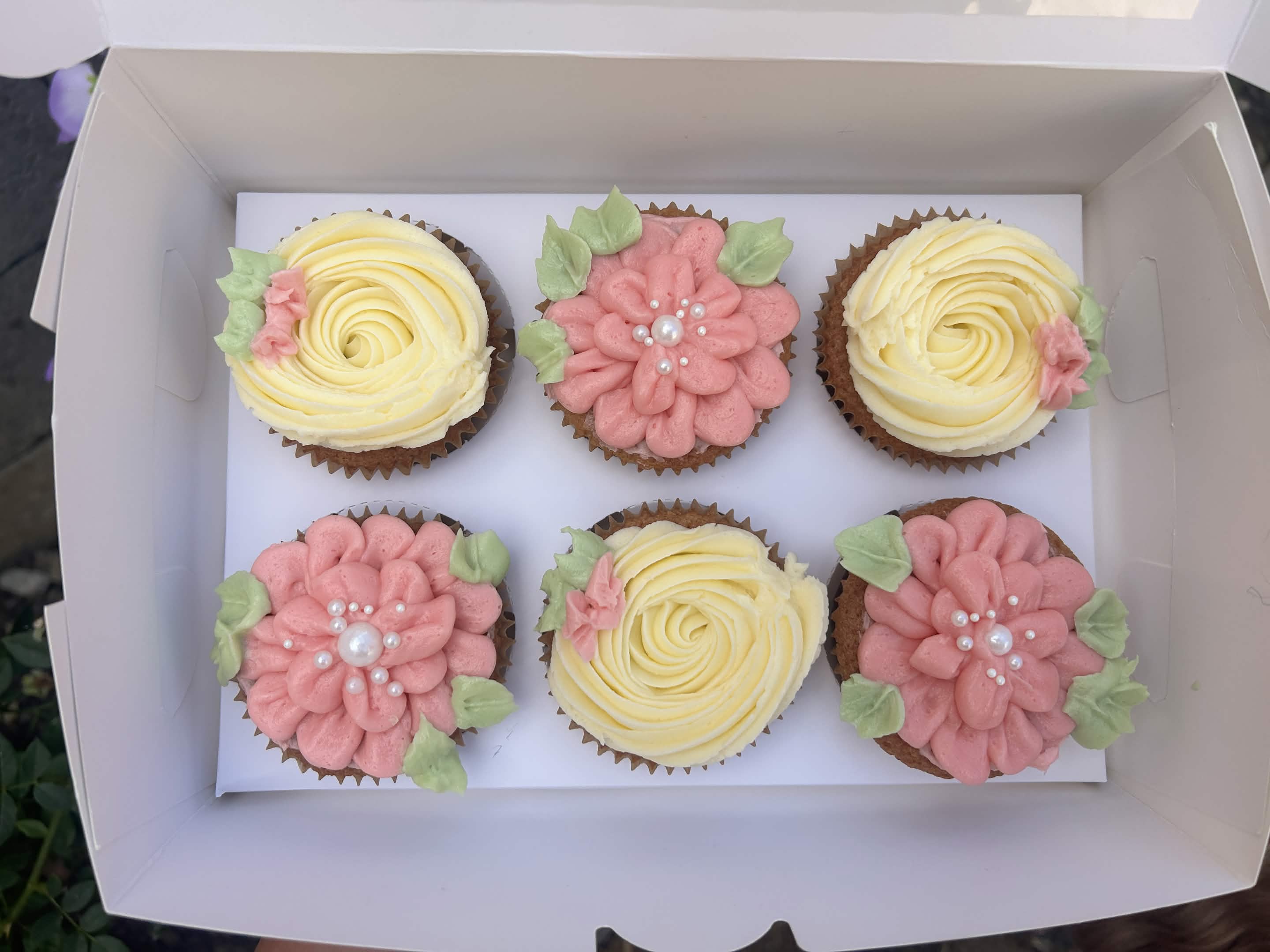 Vanilla cupcakes with custom piped flowers
